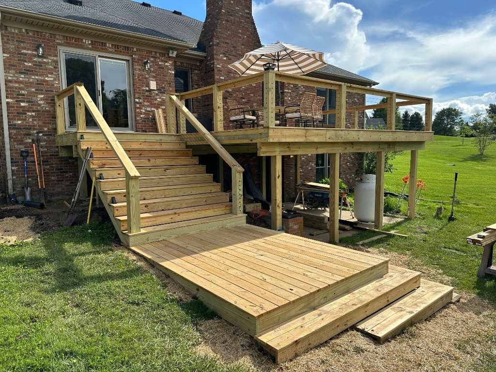Elevated deck with cable railing on a brick home