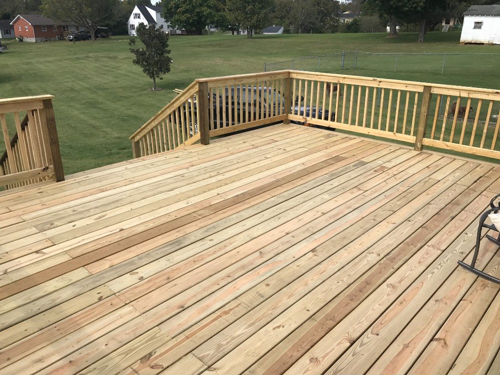 Elevated deck with diagonal board layout and wood railing