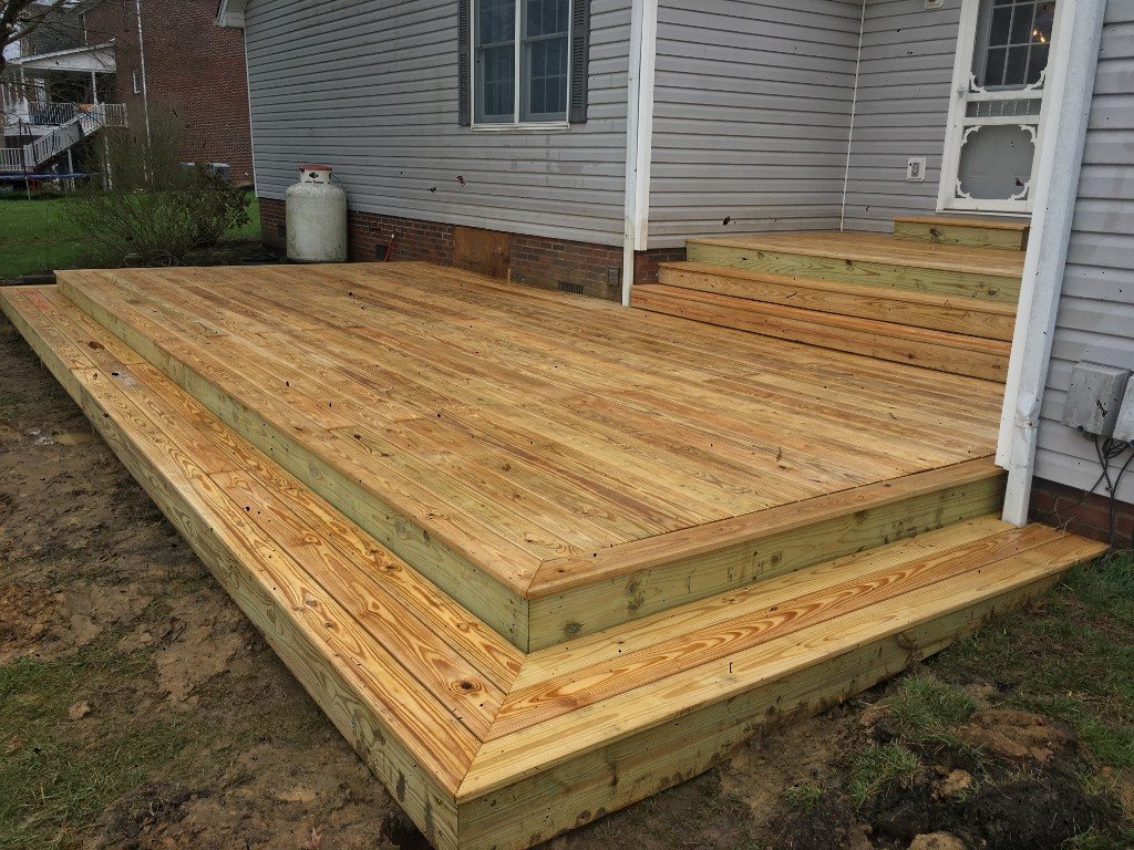 Low-profile multi-step deck on a grey siding home