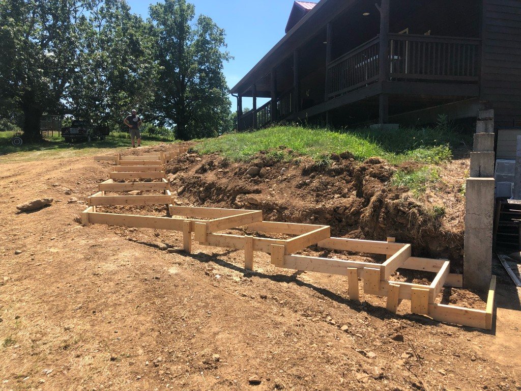 Wooden forms for hillside steps under construction