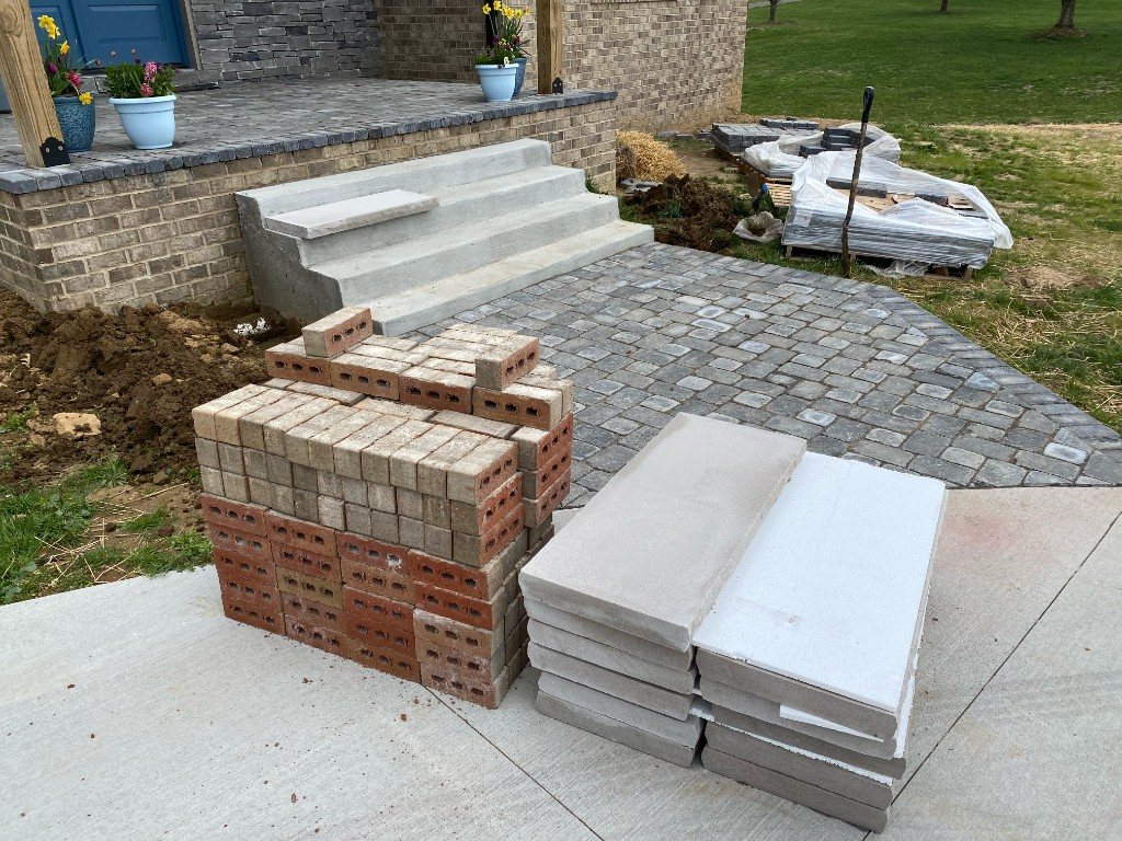 Paver patio and concrete steps under construction