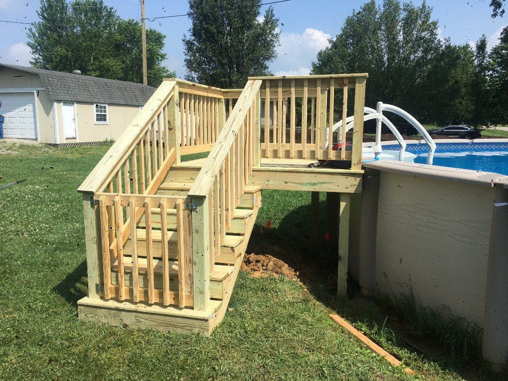Pool access stairs with safety gate and wood balusters