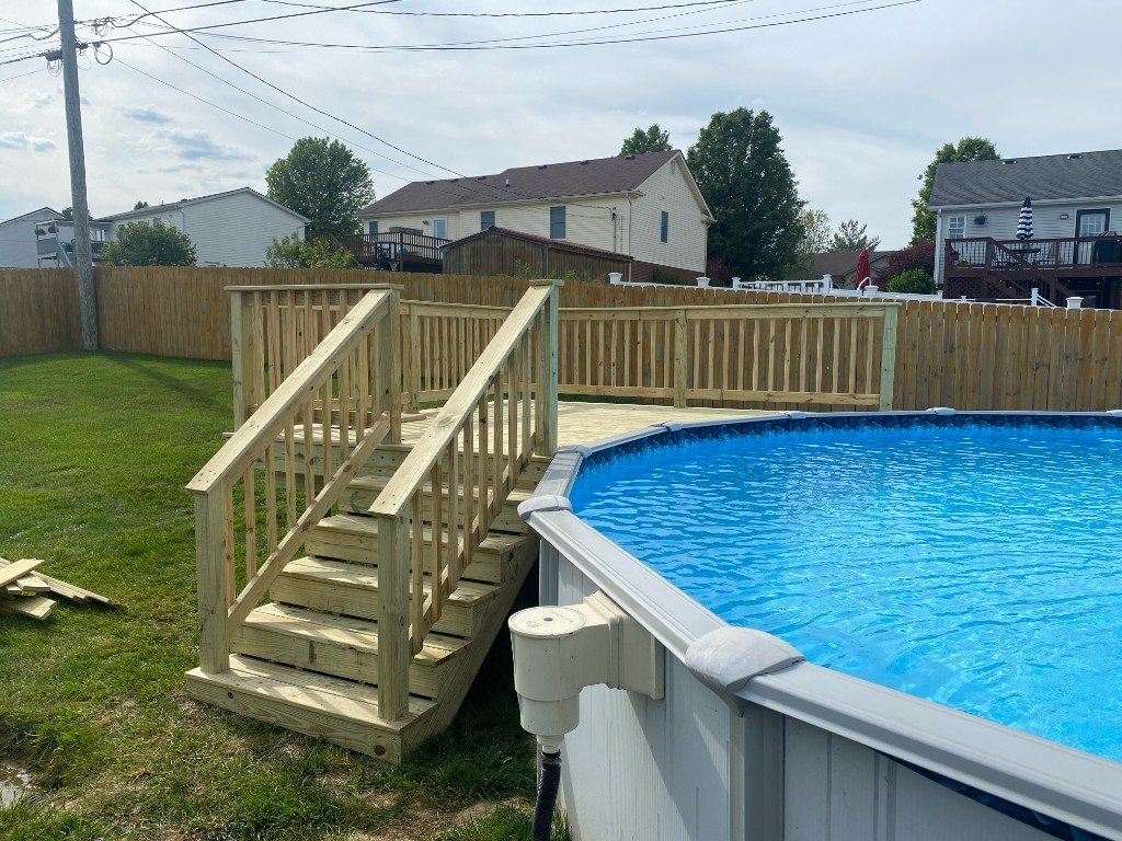 Pressure-treated deck stairs leading to an above-ground pool